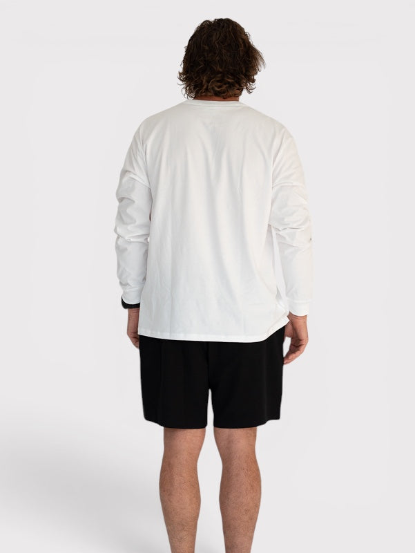 Person wearing a white long-sleeve shirt and black shorts on a white background