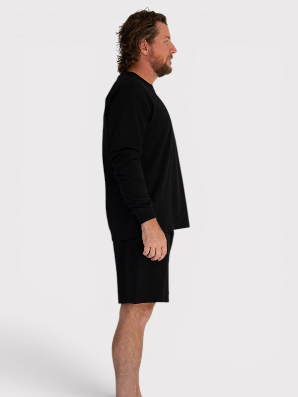 Man wearing a black dress on a white background