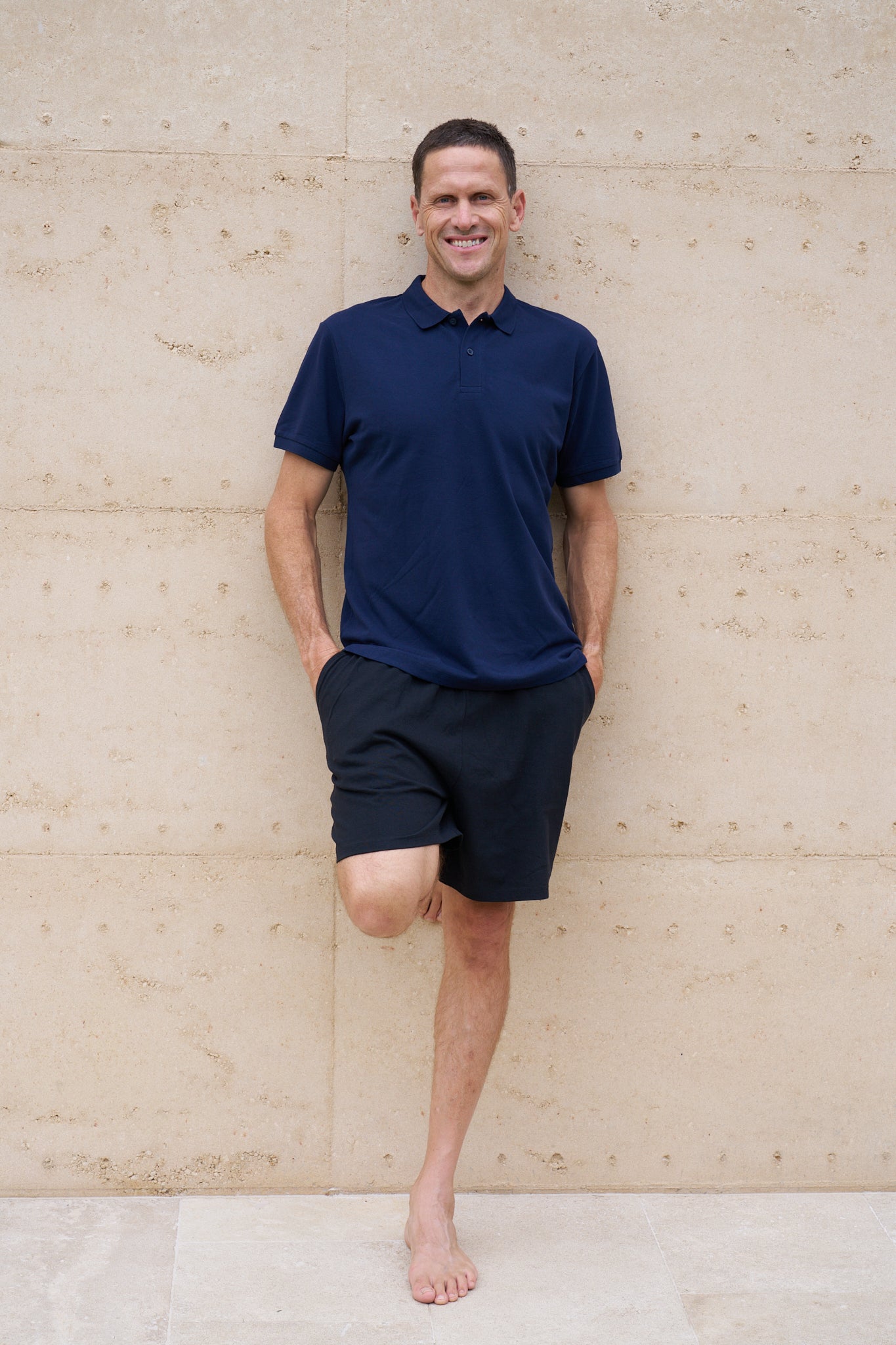 A man wearing a navy organic cotton polo