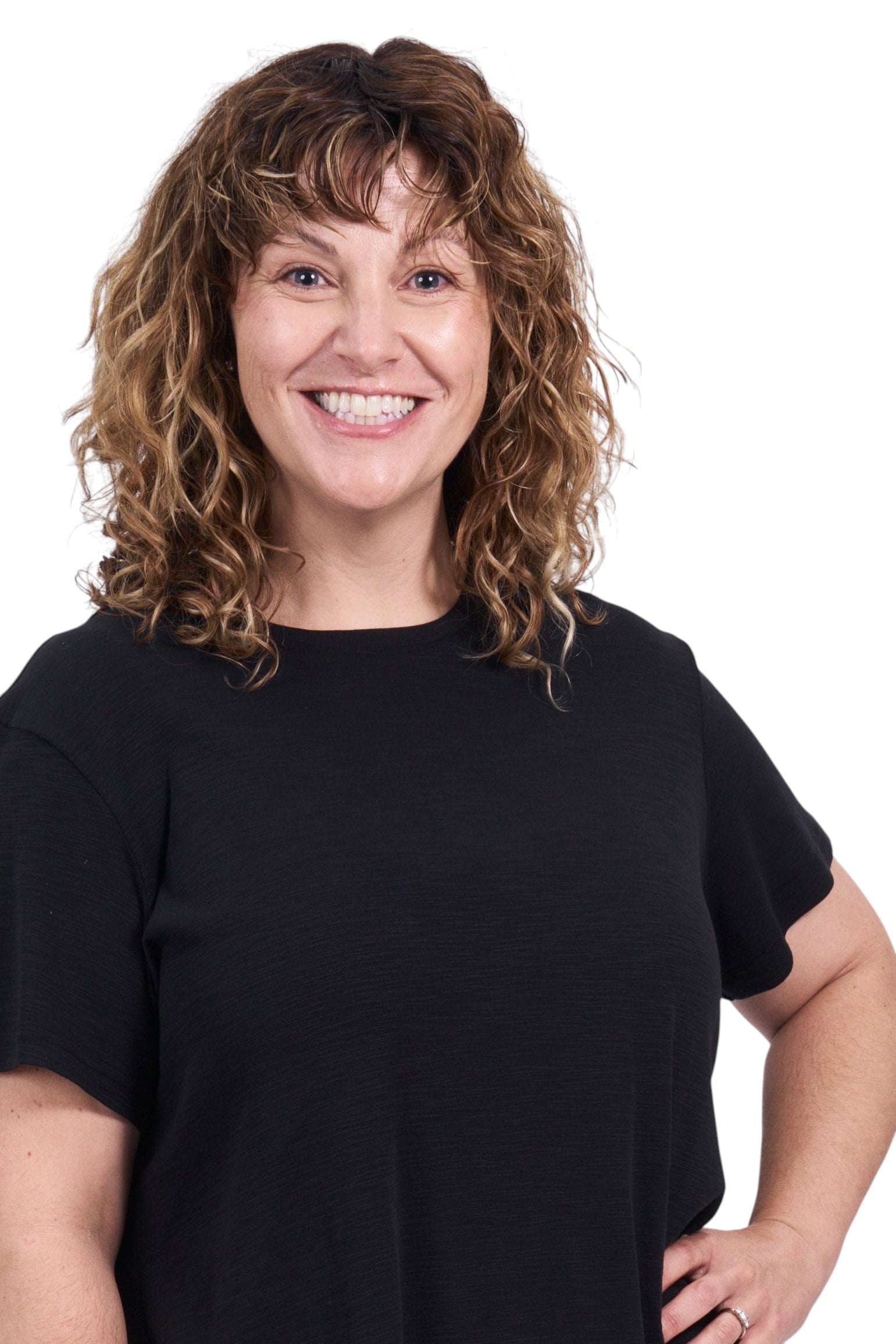 Person wearing a black t-shirt and beige shorts on a white background