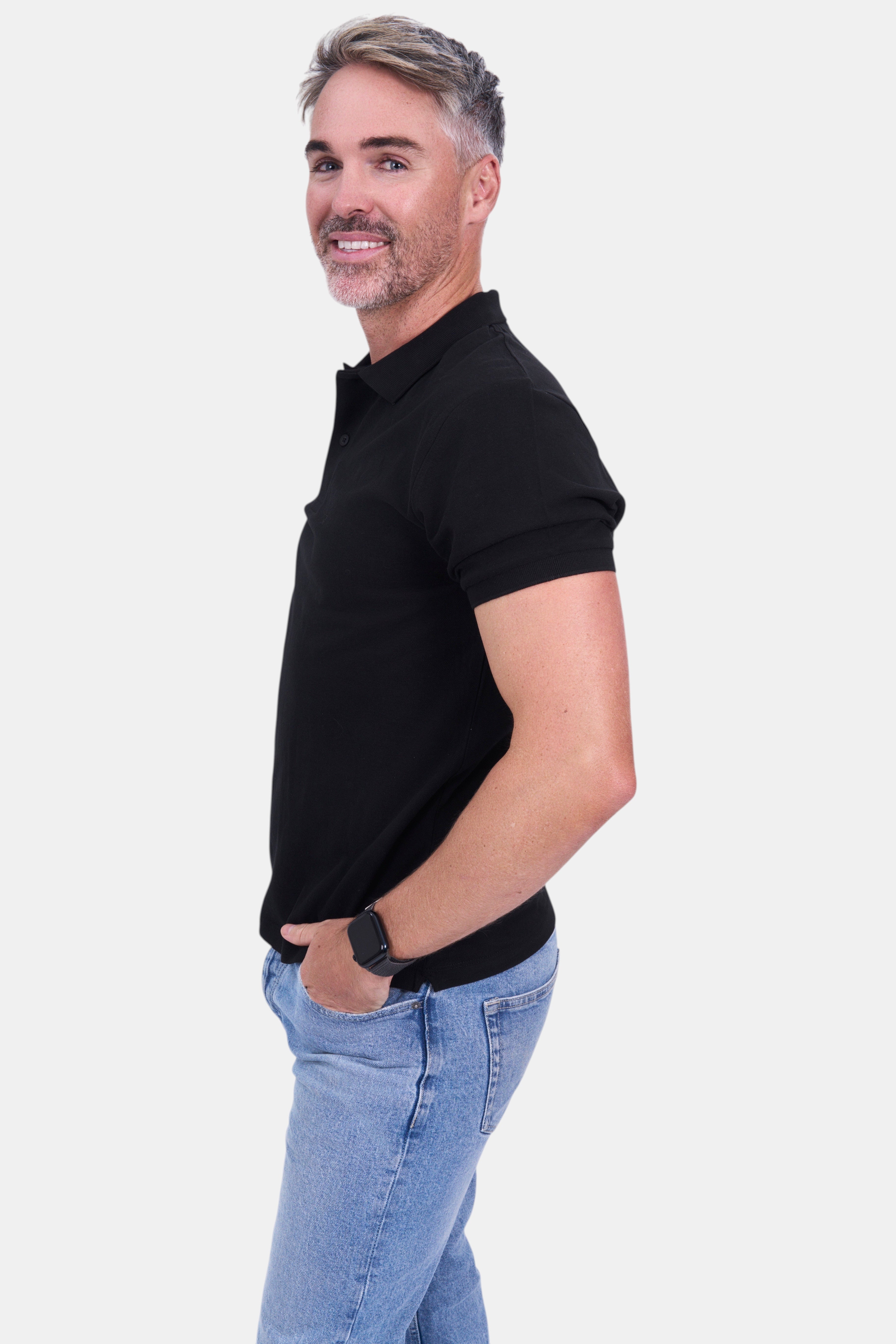 STAPLE Co black organic cotton polo shirt on a man with light wash jeans. Short sleeves, classic collar.