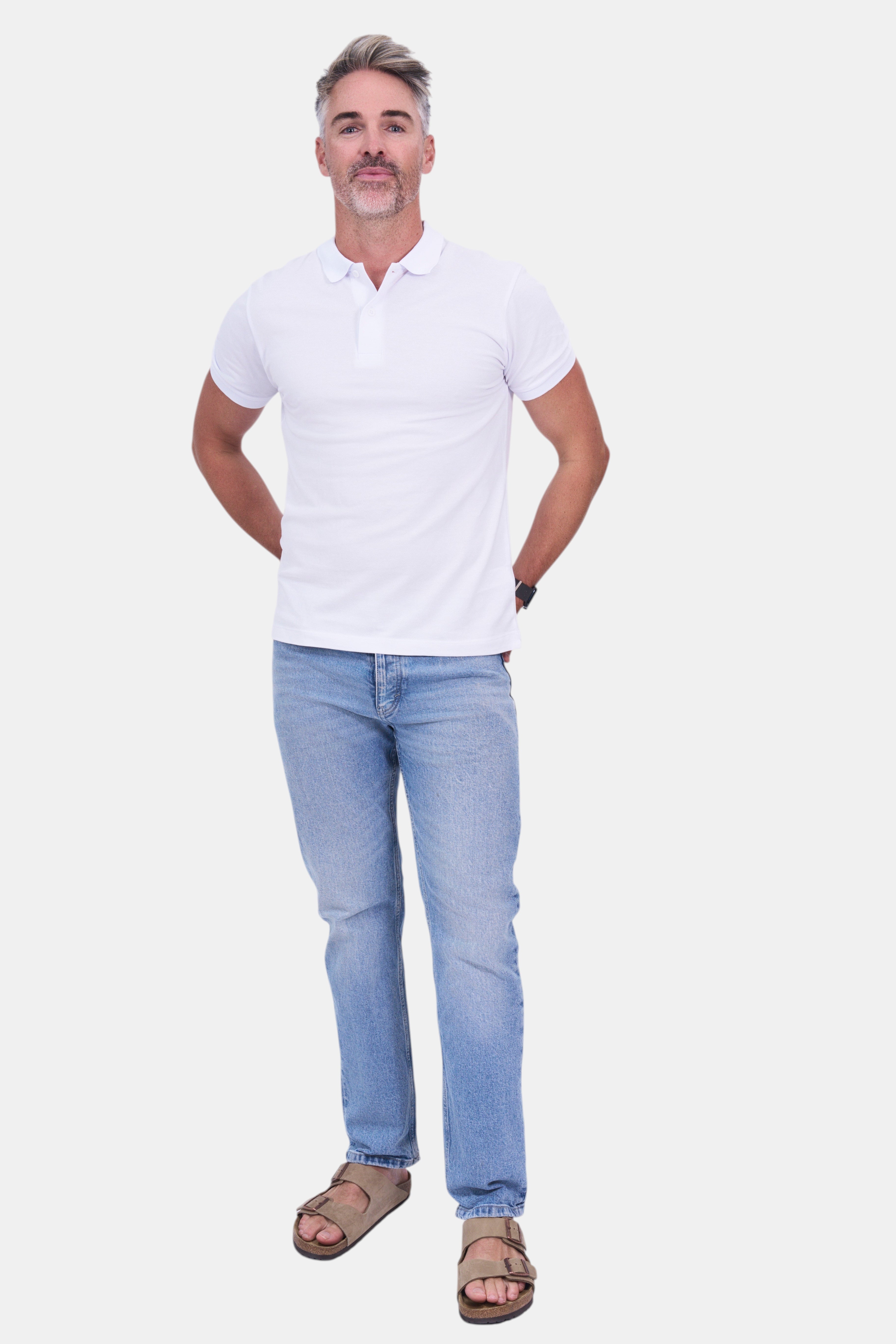 STAPLE Co white organic cotton short-sleeve polo shirt worn by a man with light blue jeans and tan sandals.