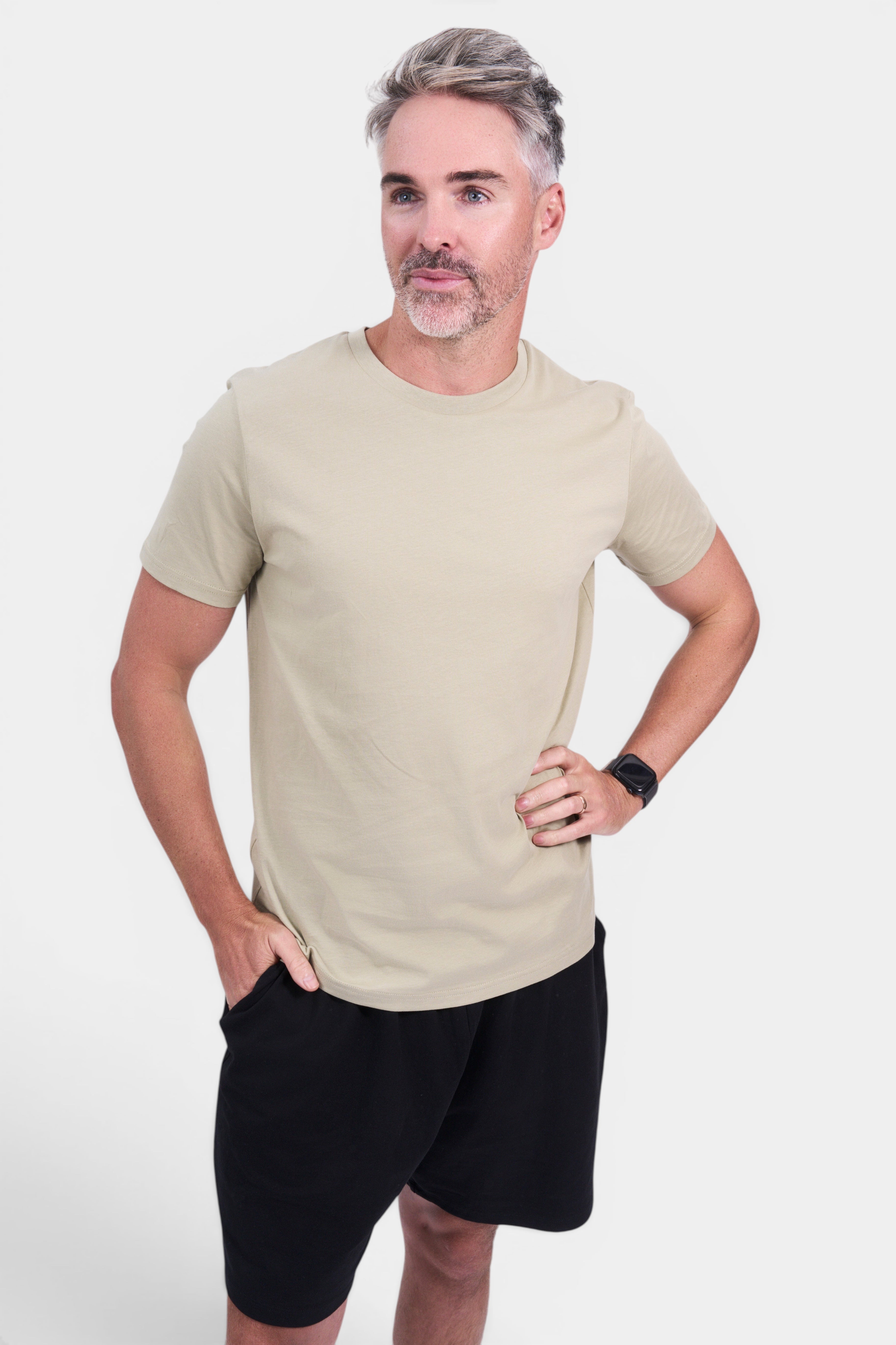 STAPLE Co. classic fit organic cotton tee in beige, worn by a man with black shorts.