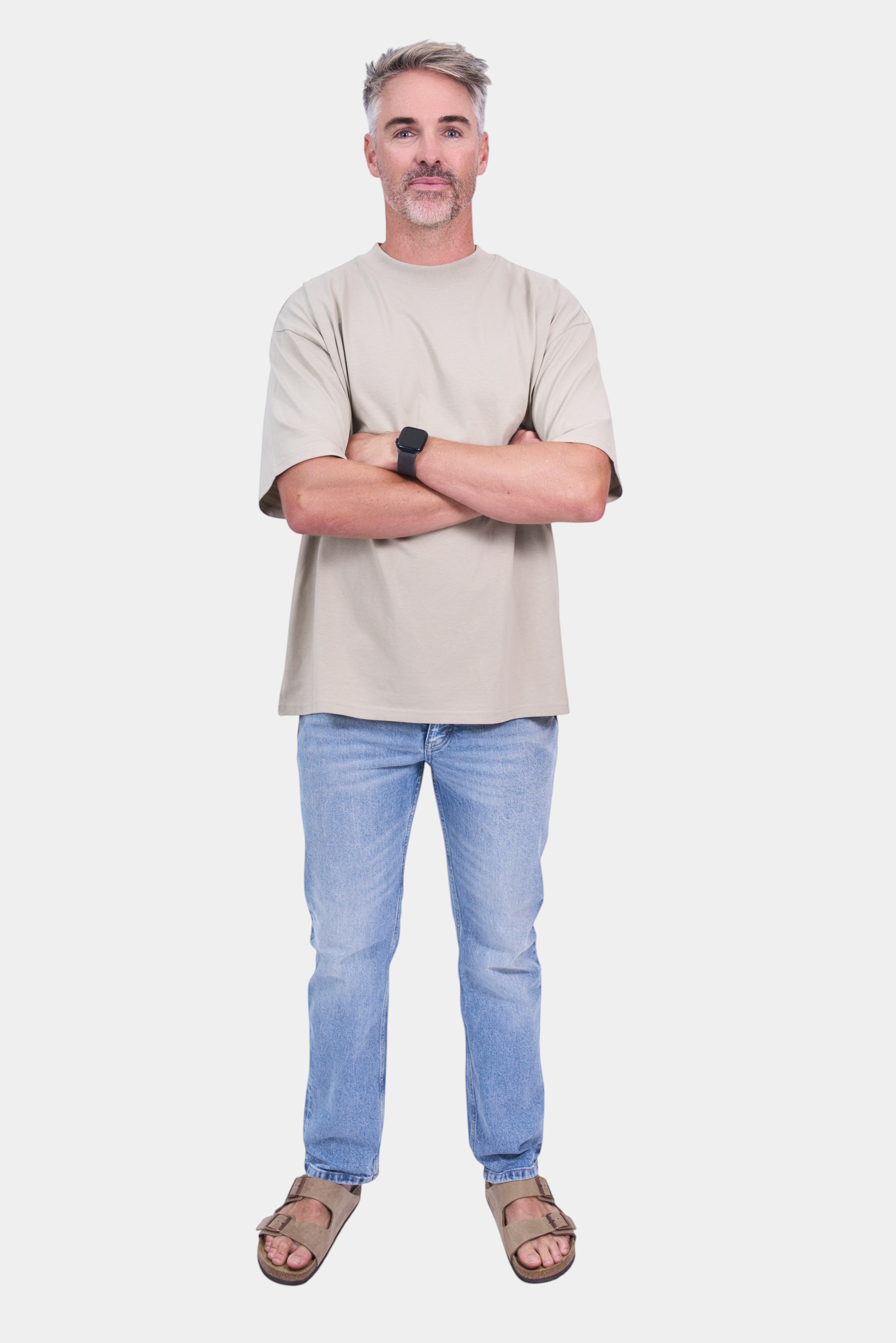 STAPLE Co high neck oversized t-shirt in organic cotton, worn by a man with arms crossed.