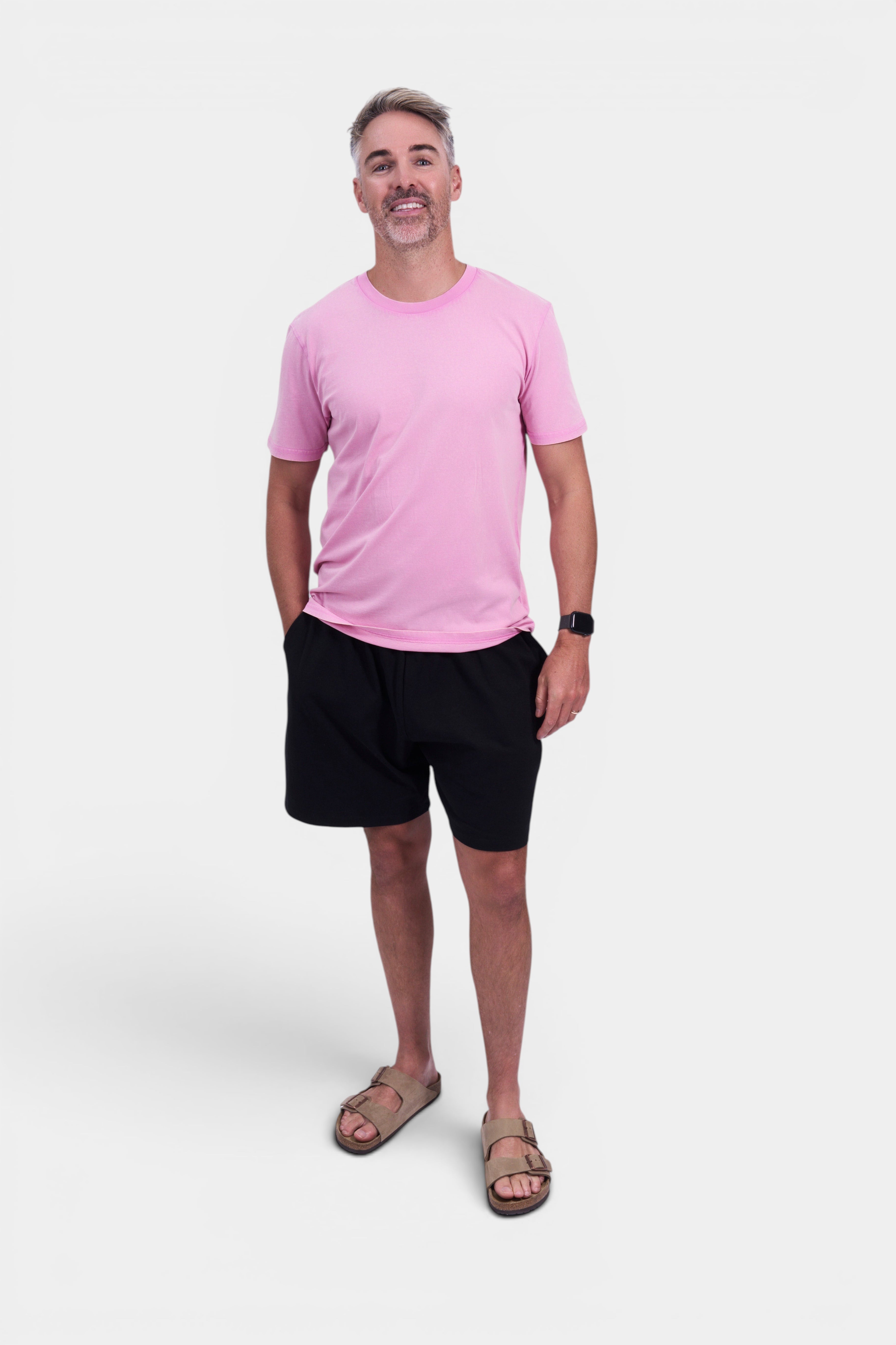 STAPLE Co pink organic cotton classic fit tee on a man wearing black shorts and tan sandals. Final sale.