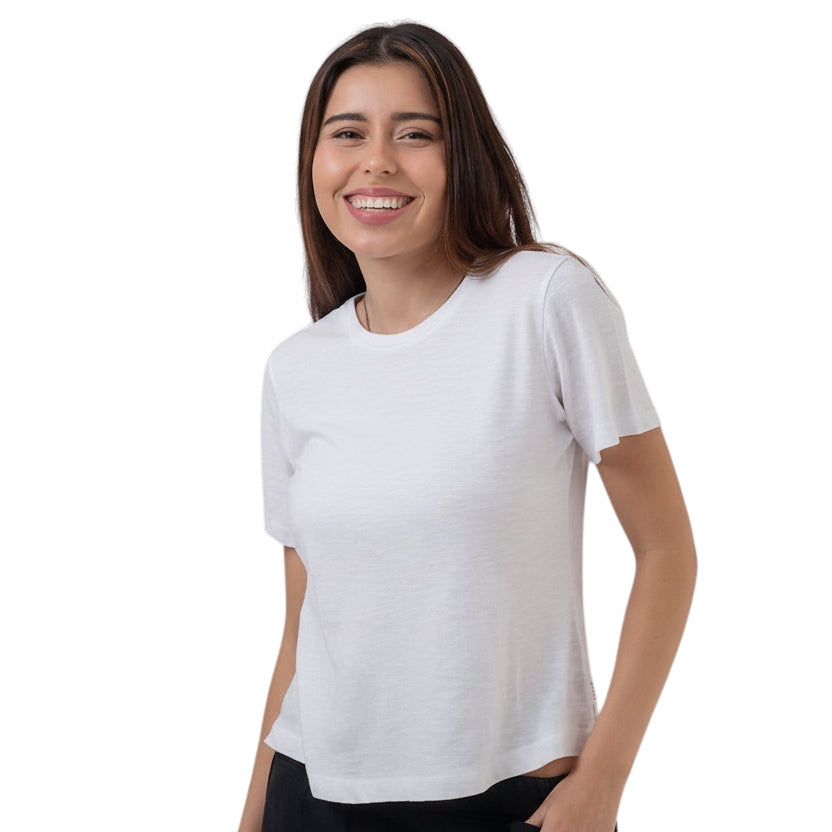 Woman wearing a white t-shirt and black pants on a white background