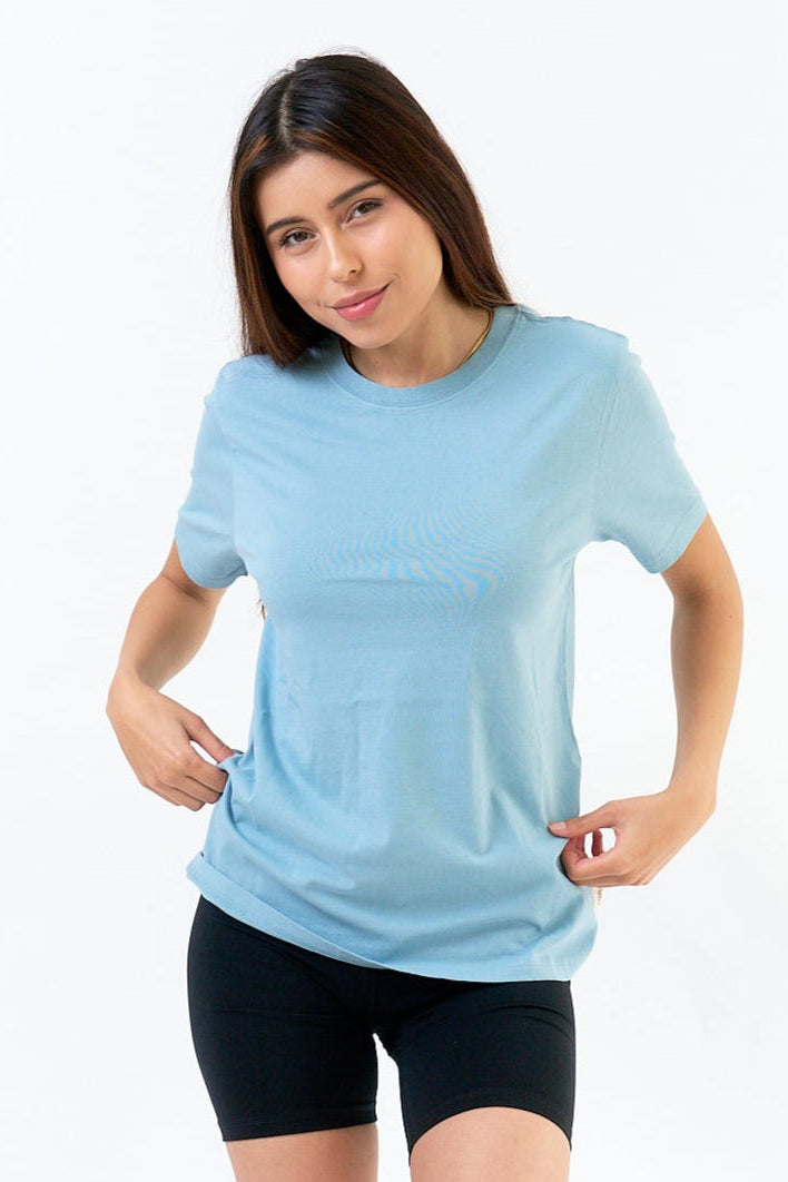 Woman wearing a light blue t-shirt and black shorts on a white background