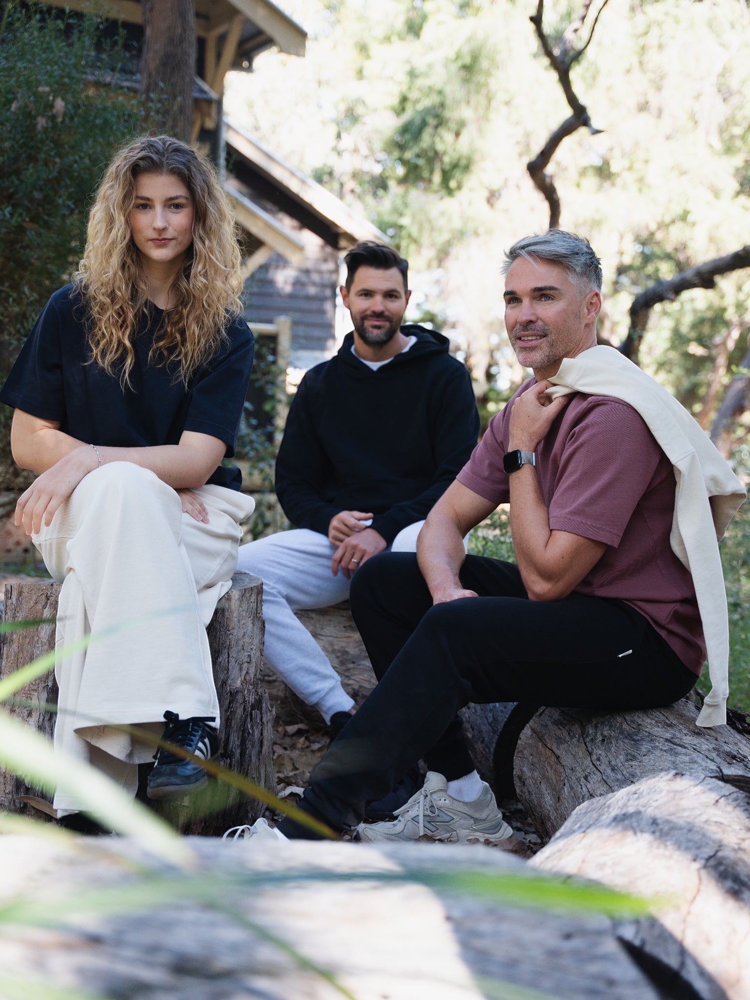 3 people wearing staple co clothing sitting down