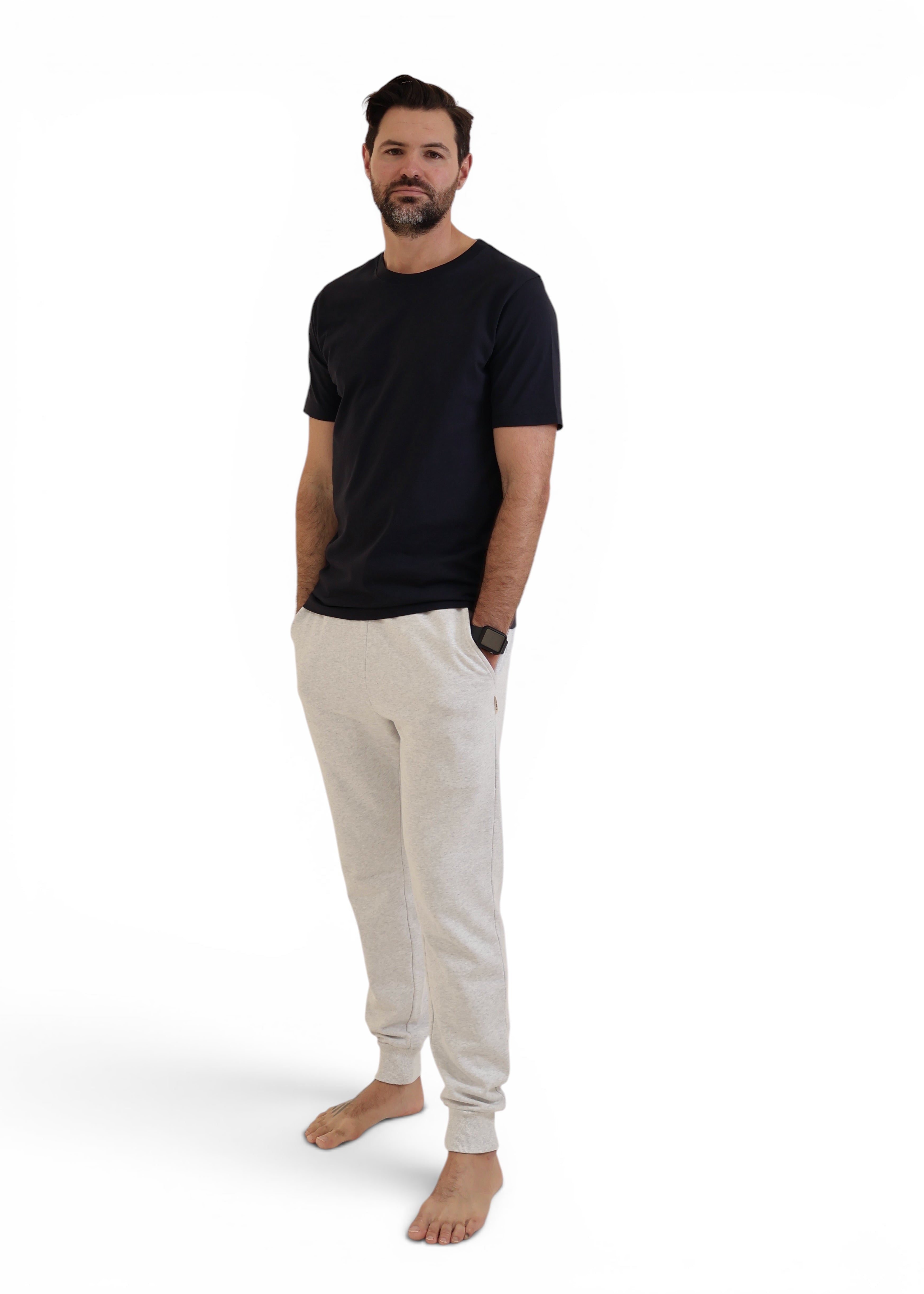 Man wearing dark navy t-shirt with grey trackpants