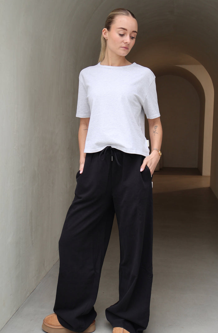 Black wide leg trackpants on female model