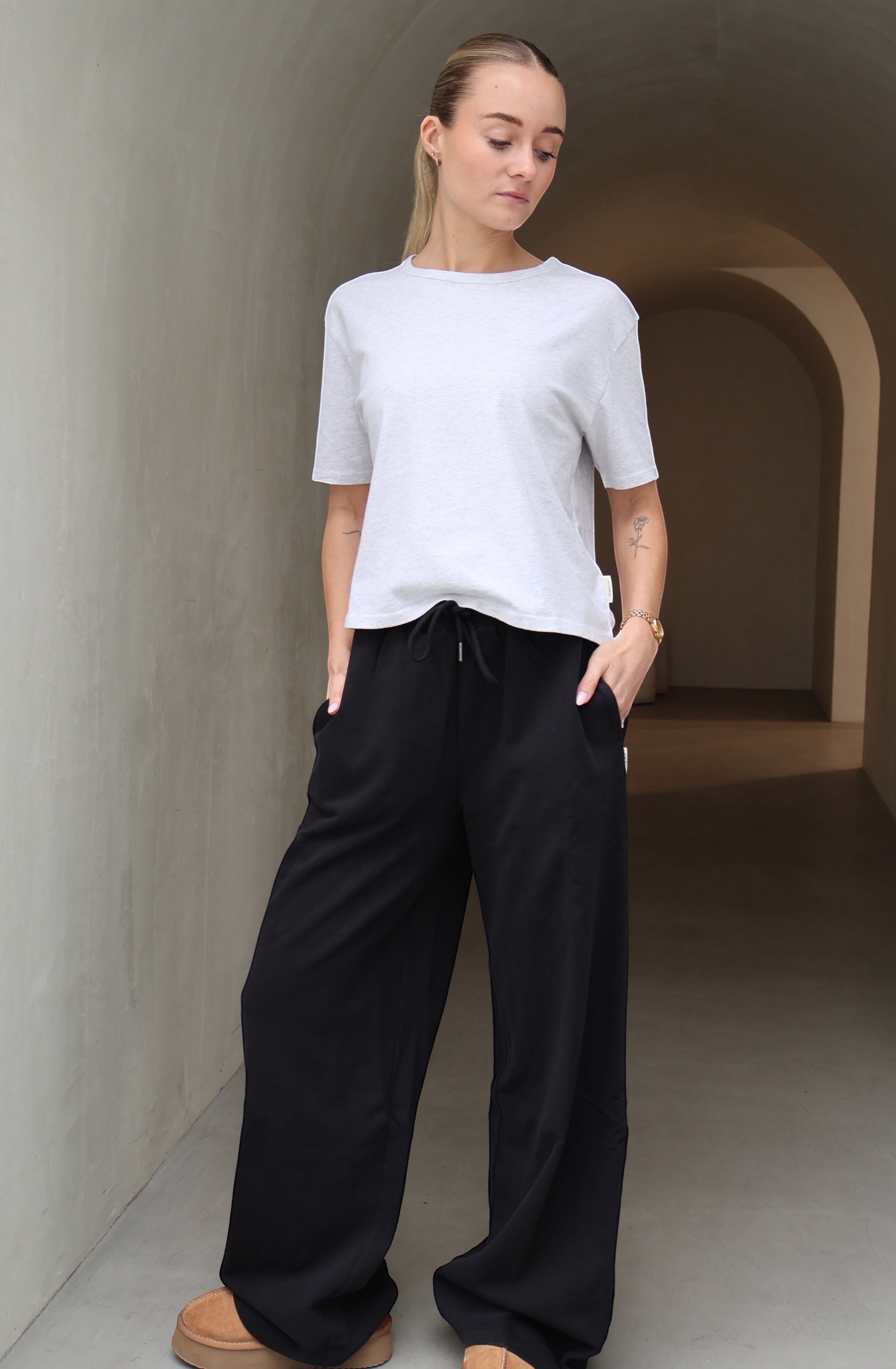Black wide leg trackpants on female model