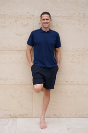 A man wearing a navy organic cotton polo