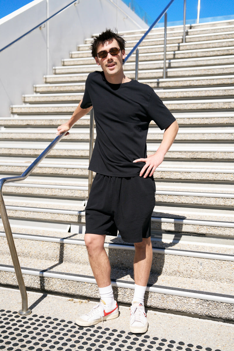 Organic cotton shorts and boxy tee worn on a coastal walk