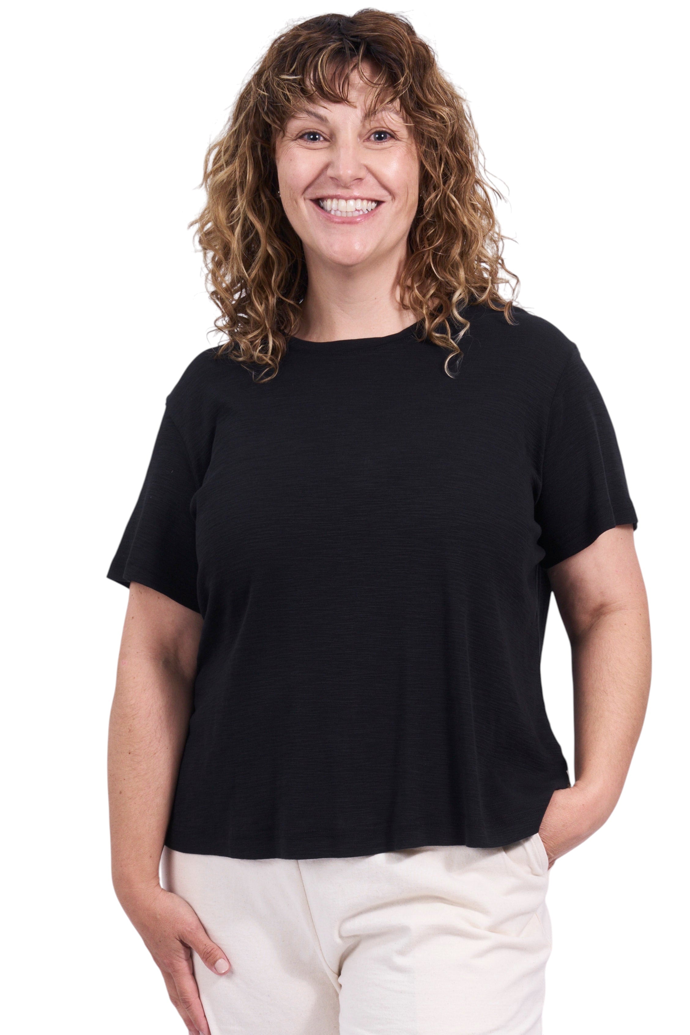 Woman wearing a black t-shirt and white shorts on a white background