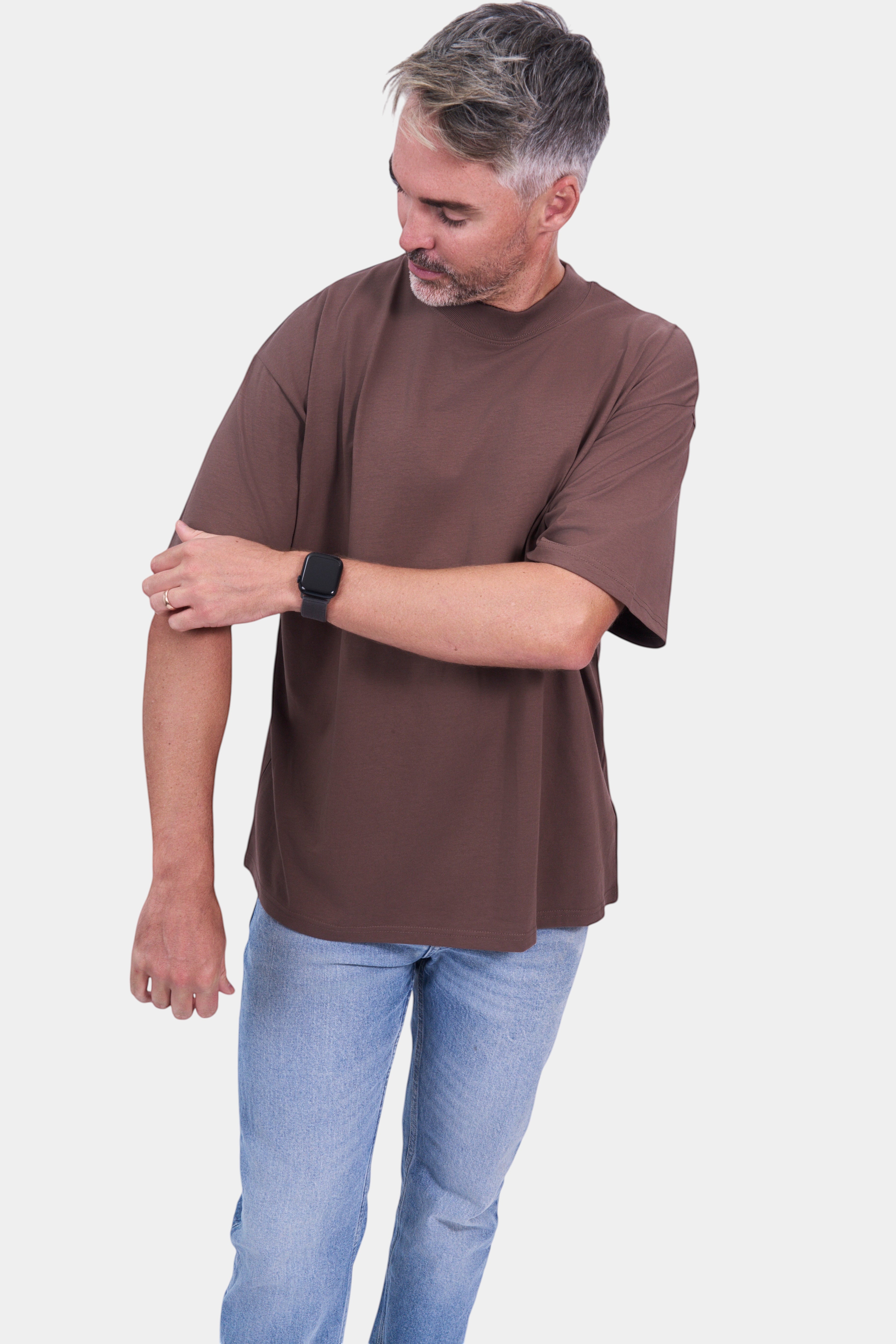 STAPLE Co. brown organic cotton oversized high neck t-shirt on a man wearing light wash jeans.