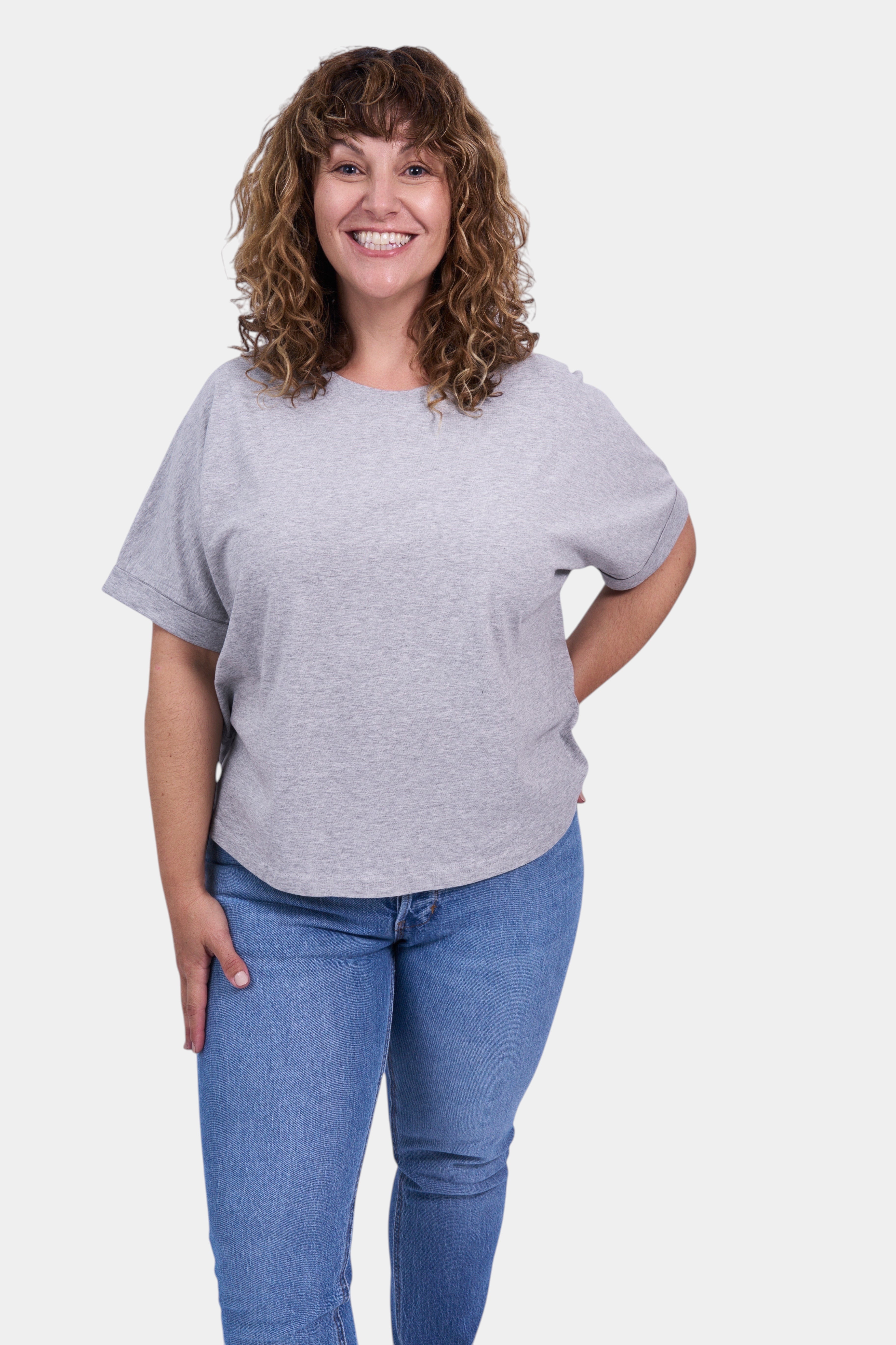 STAPLE Co grey organic cotton boxy t-shirt with rolled sleeves on a woman wearing blue jeans.