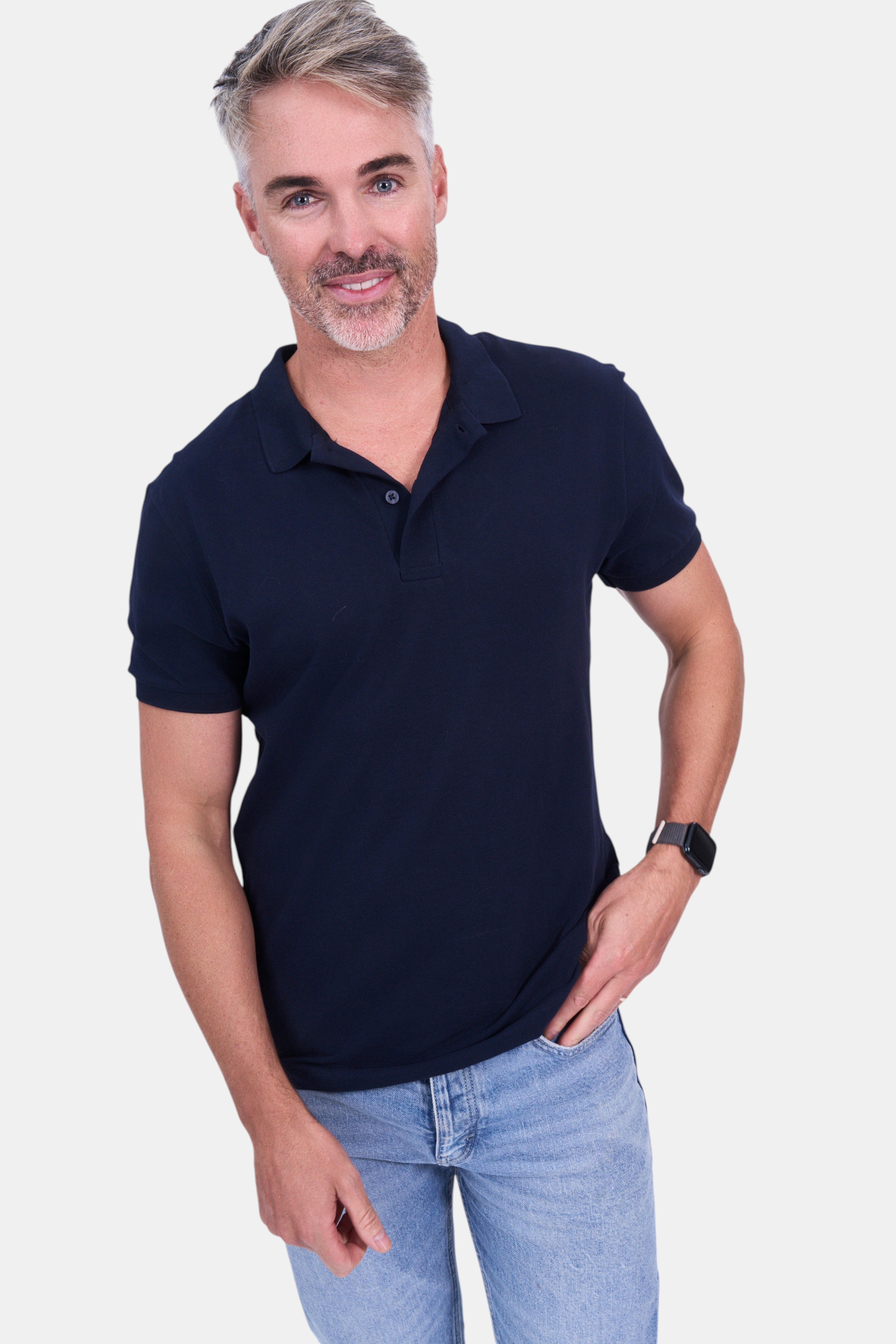 STAPLE Co navy blue organic cotton short-sleeve polo shirt on a man wearing light wash jeans.
