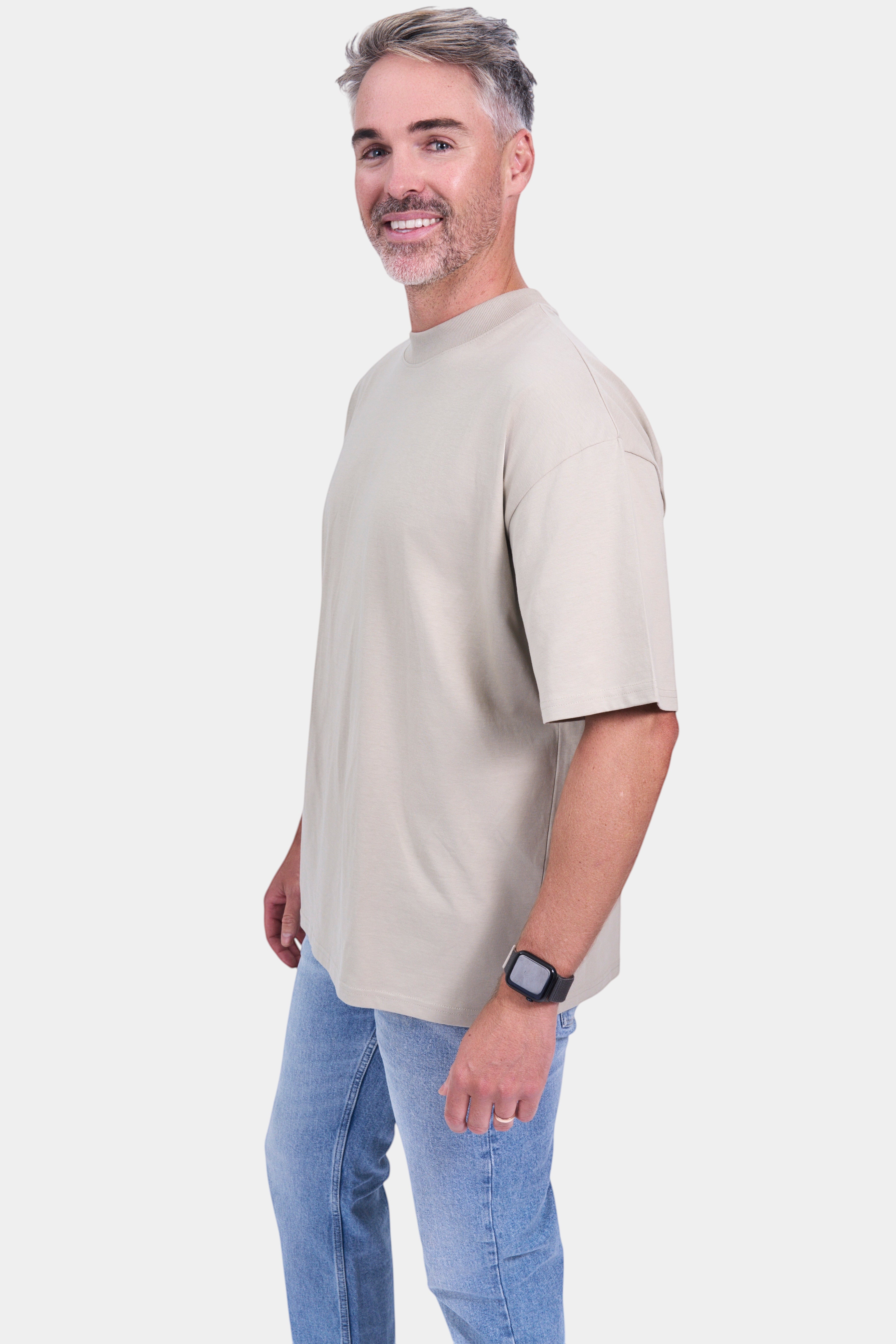 STAPLE Co organic cotton oversized high neck t-shirt on a man wearing blue jeans.