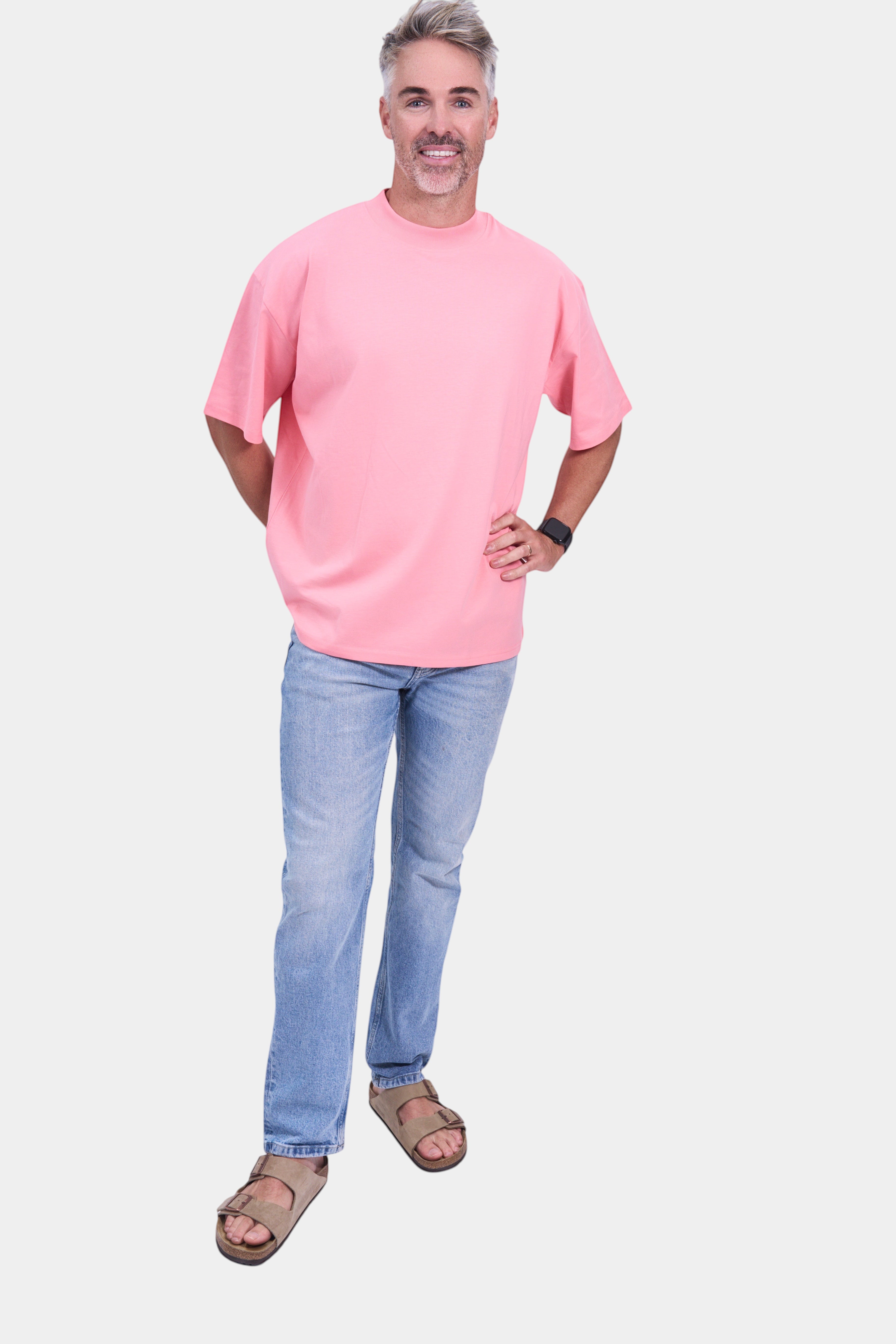 STAPLE Co pink organic cotton high neck oversized t-shirt on a man. Relaxed fit, unisex essential.