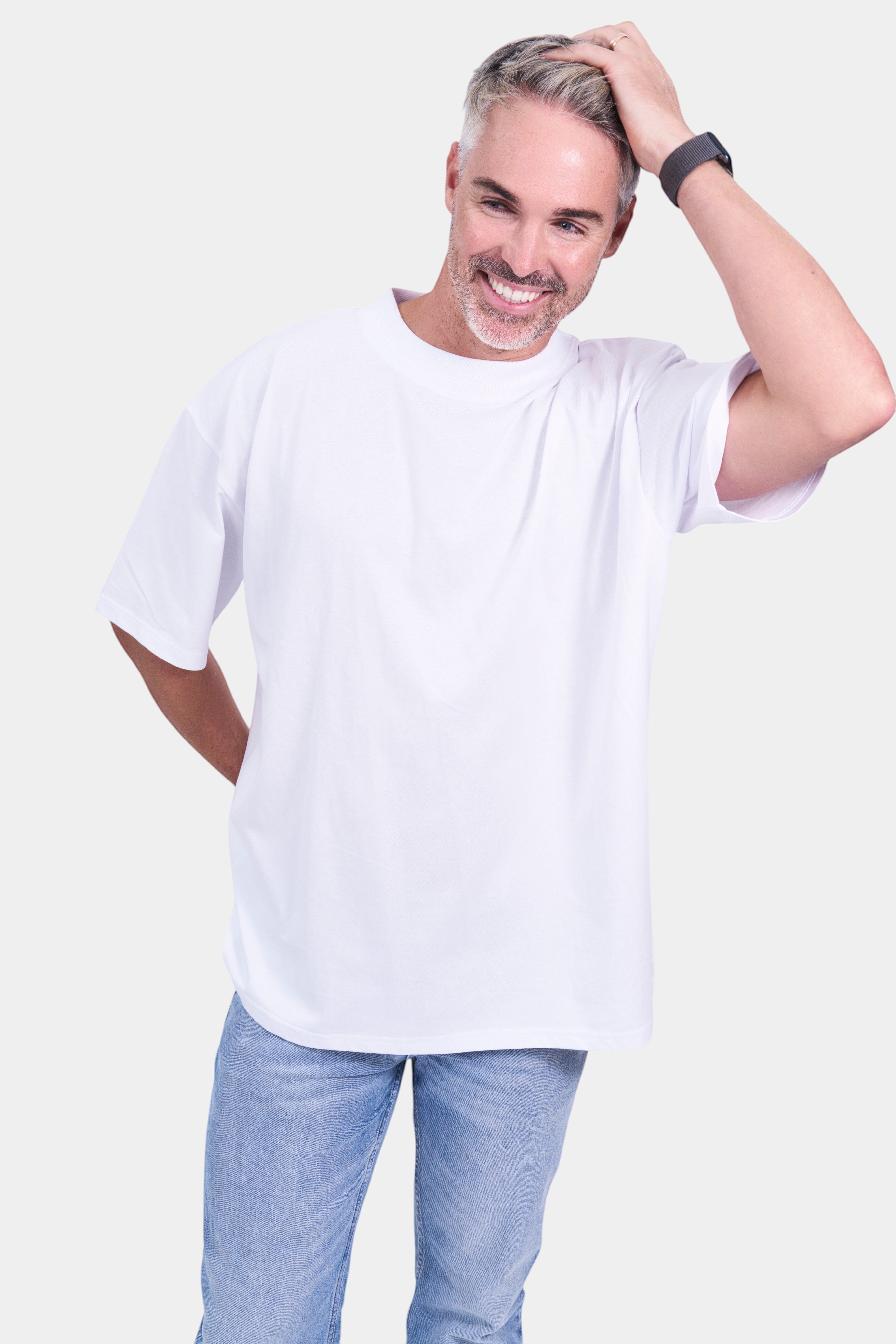 STAPLE Co white organic cotton high neck oversized t-shirt on a man with light wash jeans.
