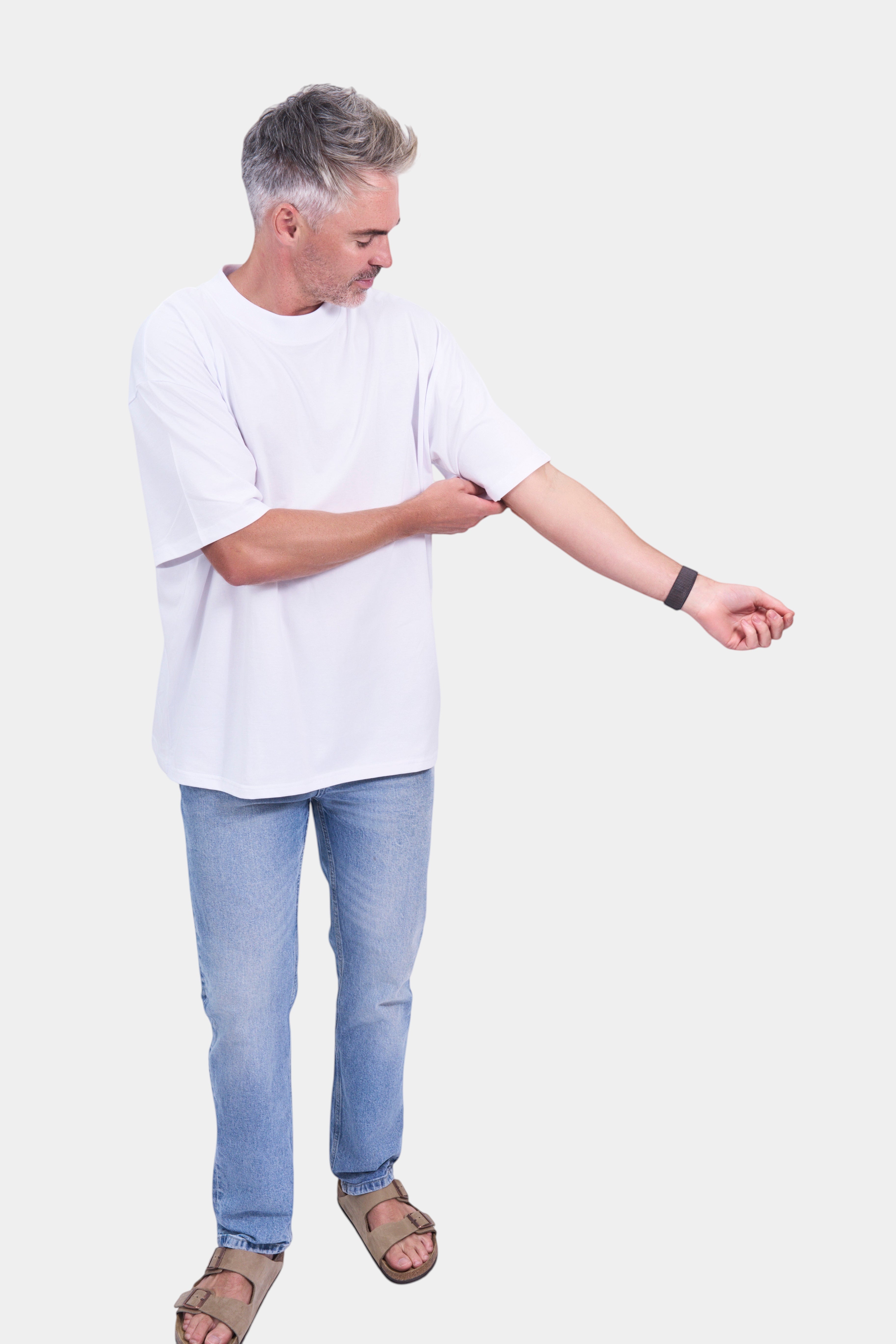 STAPLE Co white organic cotton oversized high neck t-shirt on a man rolling up his sleeve.