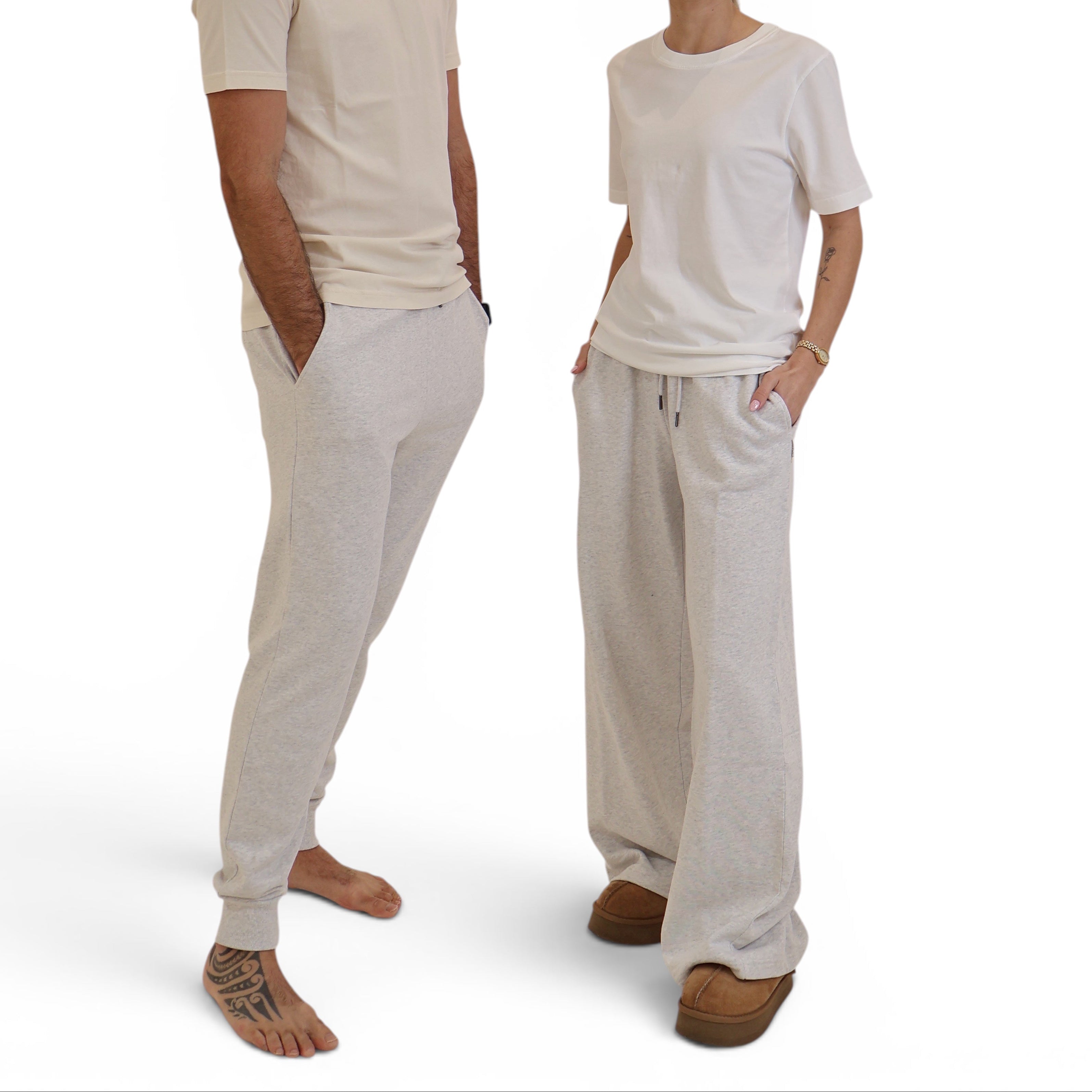 STAPLE Co wide leg trackpants in light grey organic cotton worn by a man and woman in a studio setting